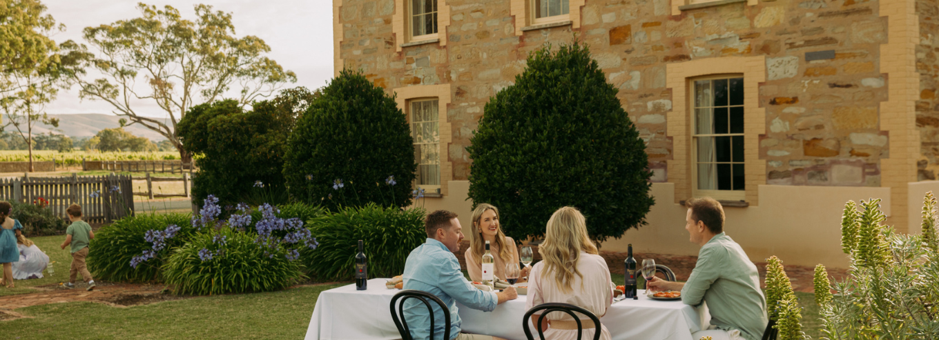 People at at table outside enjoying Penny's Hill wines